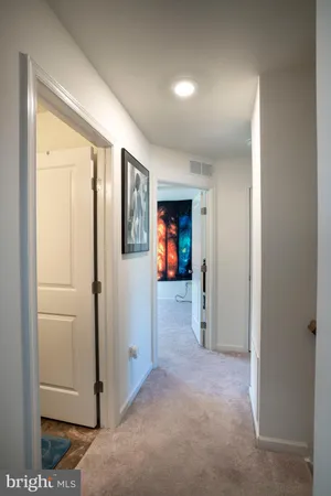 a view of a hallway with wooden shelves