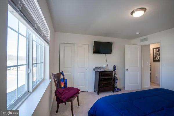 a bedroom with furniture and a large window