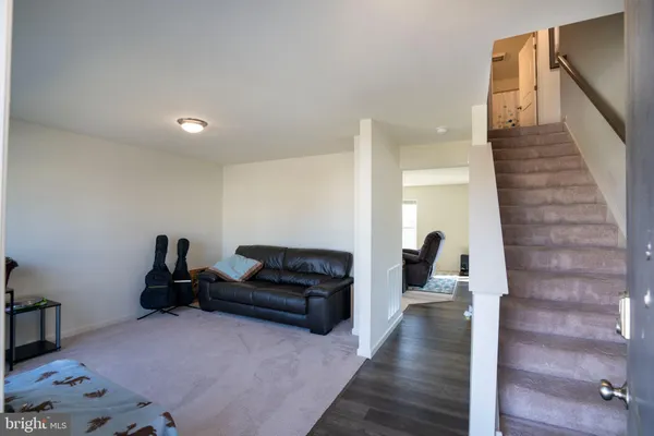 a living room with furniture and a hard wood floor