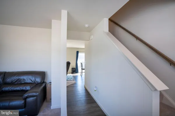 a hallway with wooden floor and furniture