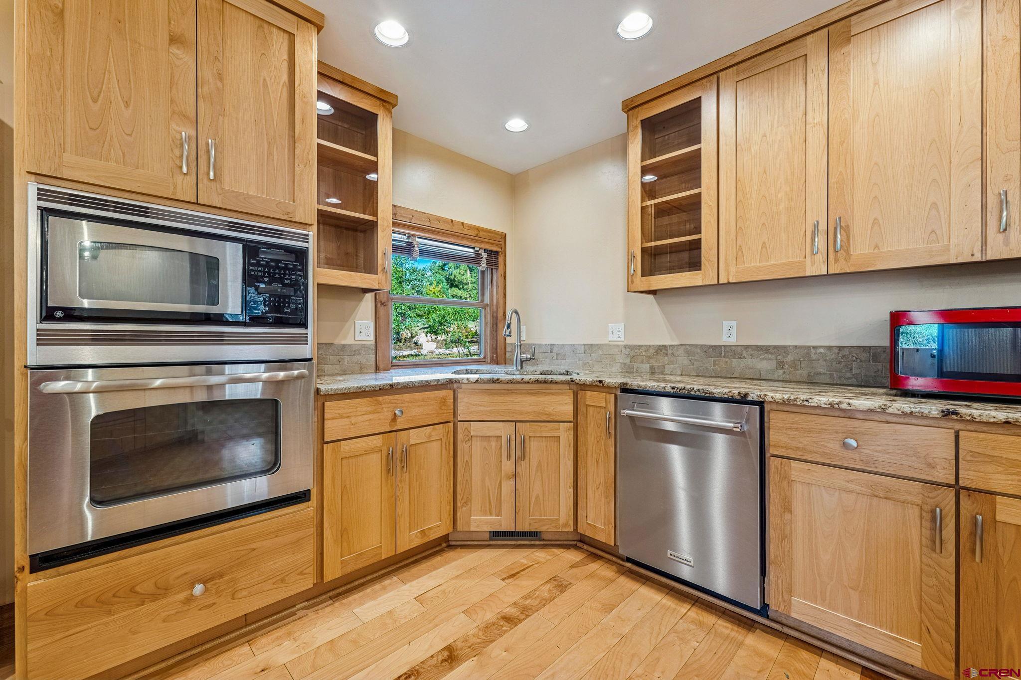157 Window Lake Trail Durango, CO 81301 - Photo 12 of 39 a kitchen with stainless steel appliances granite countertop a stove a microwave and cabinets