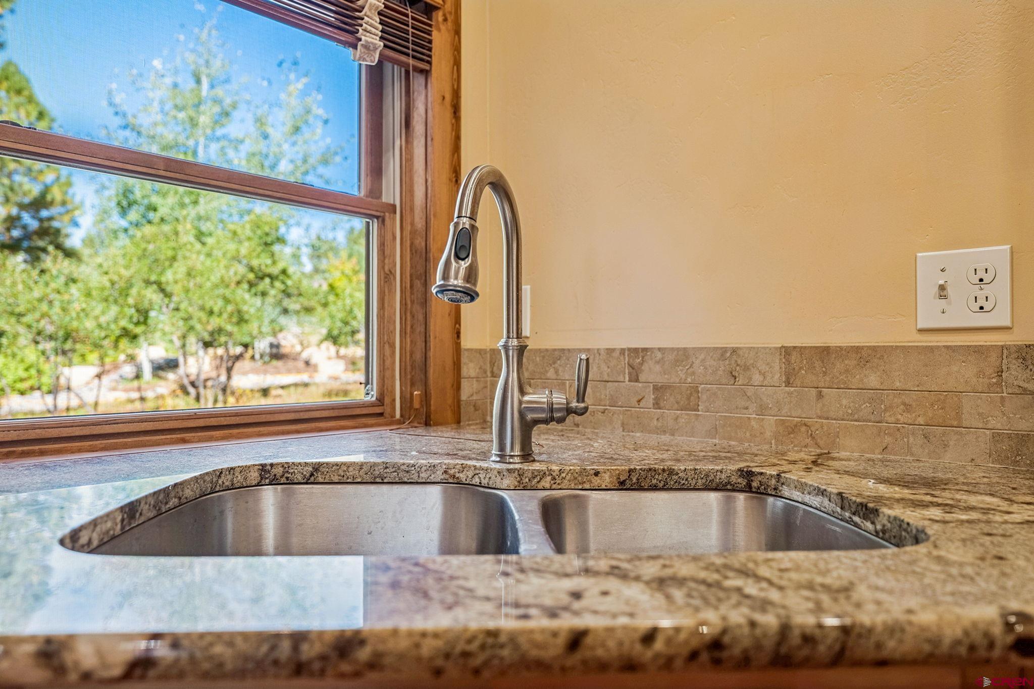157 Window Lake Trail Durango, CO 81301 - Photo 14 of 39 a view of a kitchen island with a sink and a window
