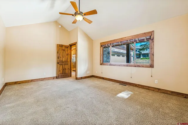 a spacious bathroom with a granite countertop sink a toilet a mirror and bathtub