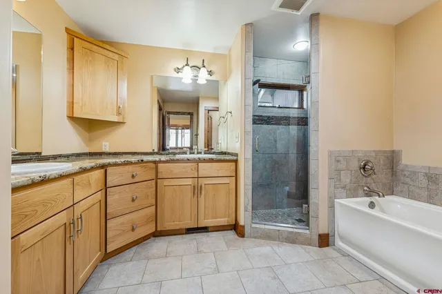 a spacious bathroom with a bathtub and a shower