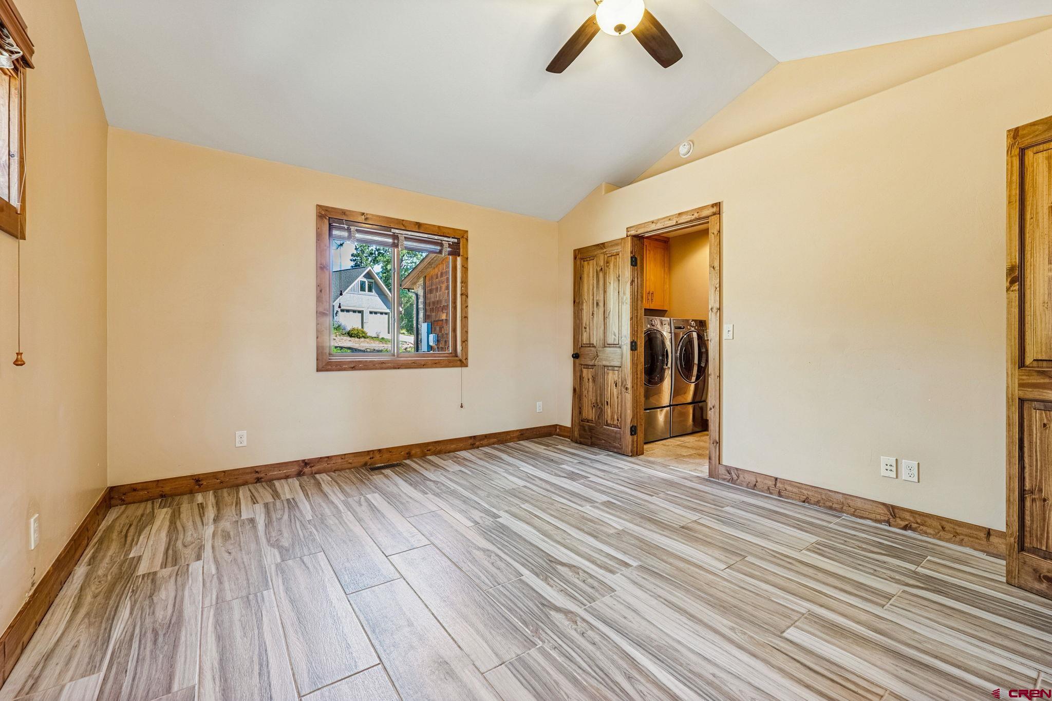 157 Window Lake Trail Durango, CO 81301 - Photo 23 of 39 a view of an empty room with wooden floor and a window