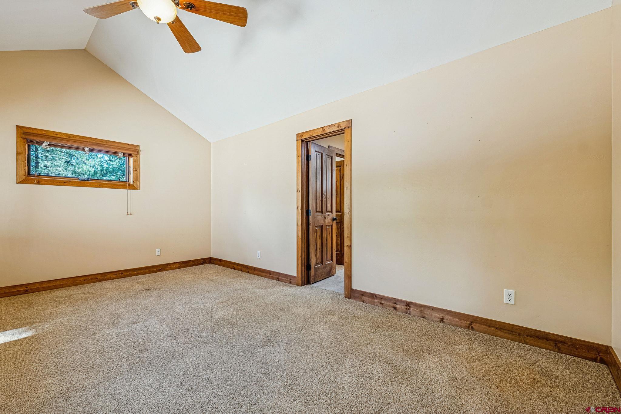 157 Window Lake Trail Durango, CO 81301 - Photo 26 of 39 an empty room with ceiling fan and window