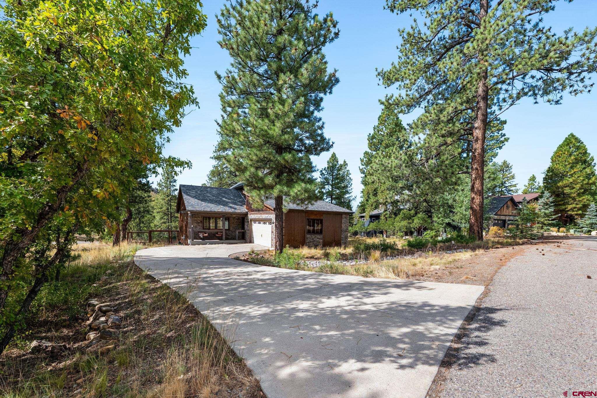 157 Window Lake Trail Durango, CO 81301 - Photo 3 of 39 a front view of a house with a yard and garage