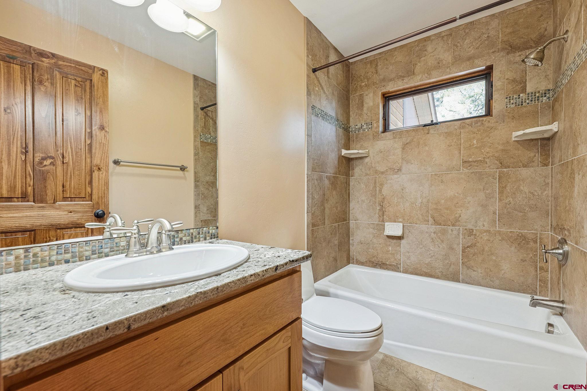 157 Window Lake Trail Durango, CO 81301 - Photo 31 of 39 a bathroom with a granite countertop sink toilet and shower