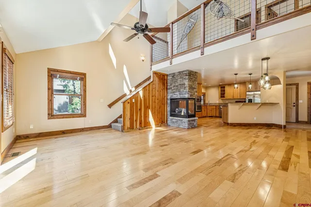 a view of a livingroom with wooden floor and stairs