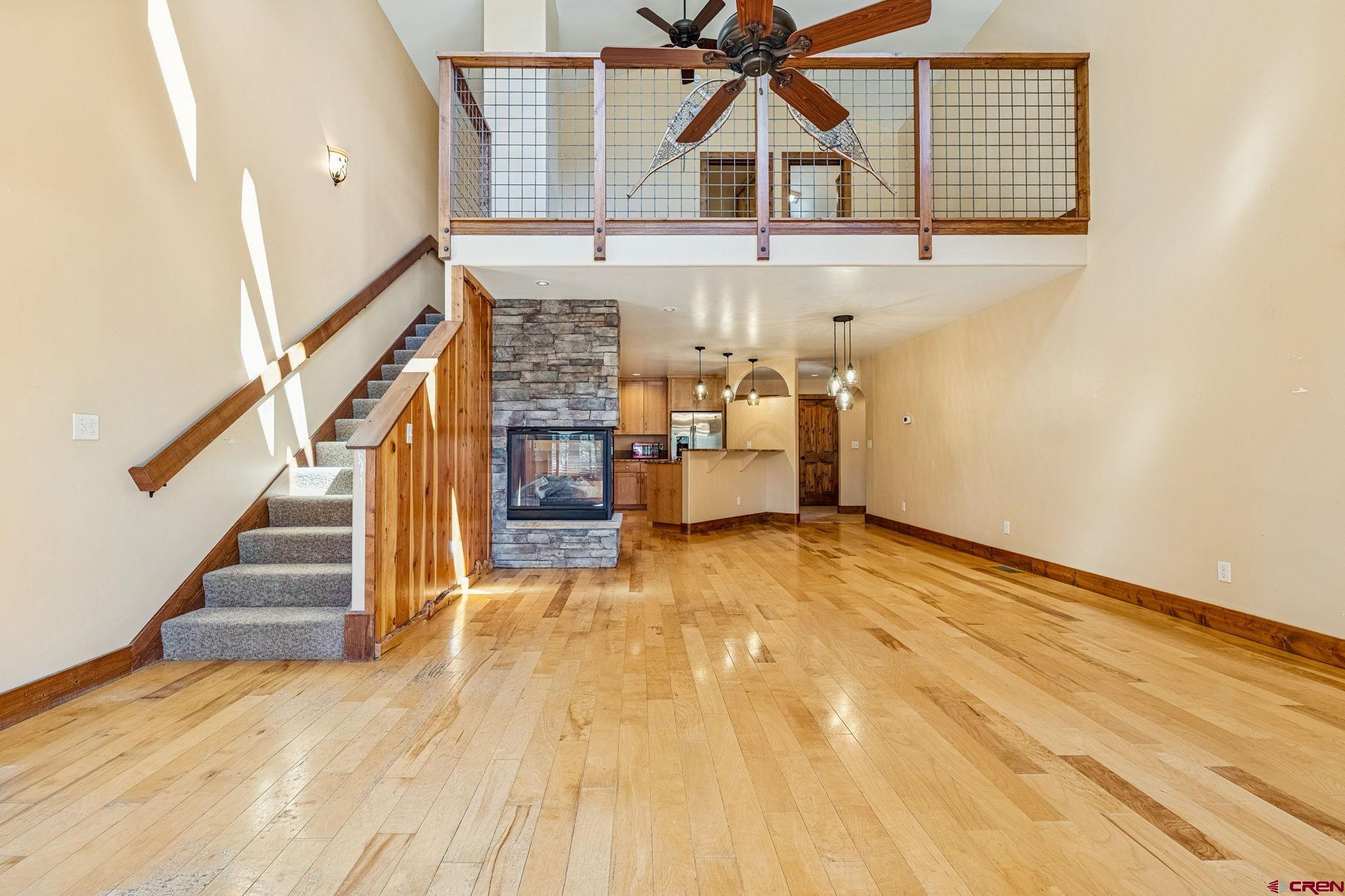 157 Window Lake Trail Durango, CO 81301 - Photo 6 of 39 a view of a livingroom with wooden floor and stairs