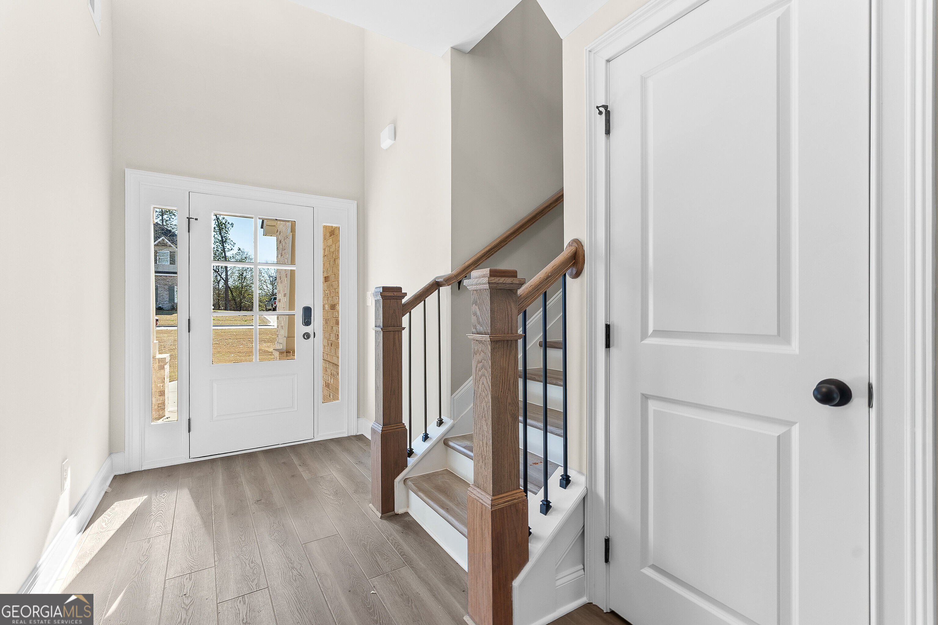 310 Air View Drive Warner Robins, GA 31093 - Photo 13 of 66 a view of a hallway with wooden floor and staircase