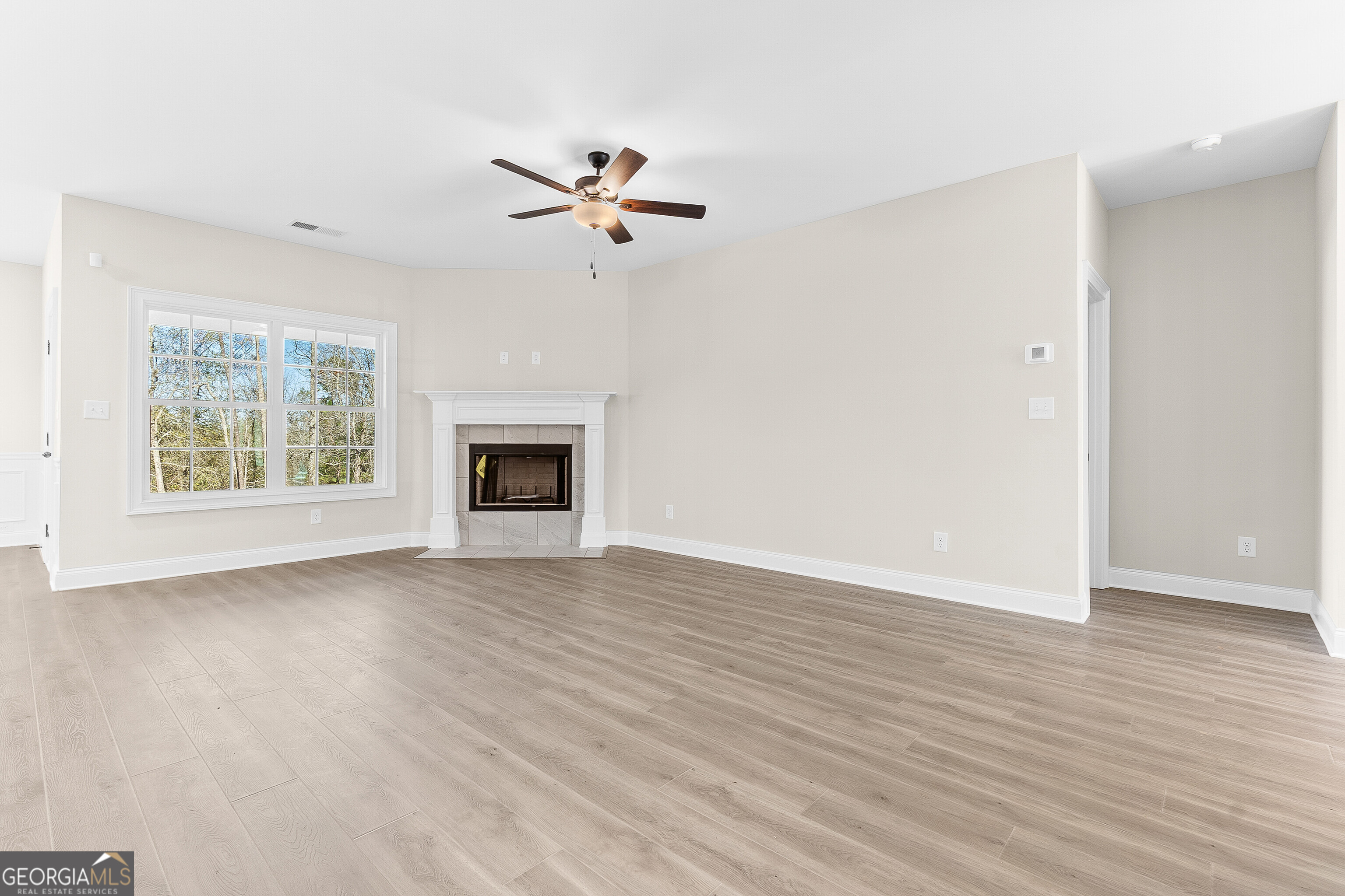 310 Air View Drive Warner Robins, GA 31093 - Photo 15 of 66 a view of empty room with wooden floor and fireplace