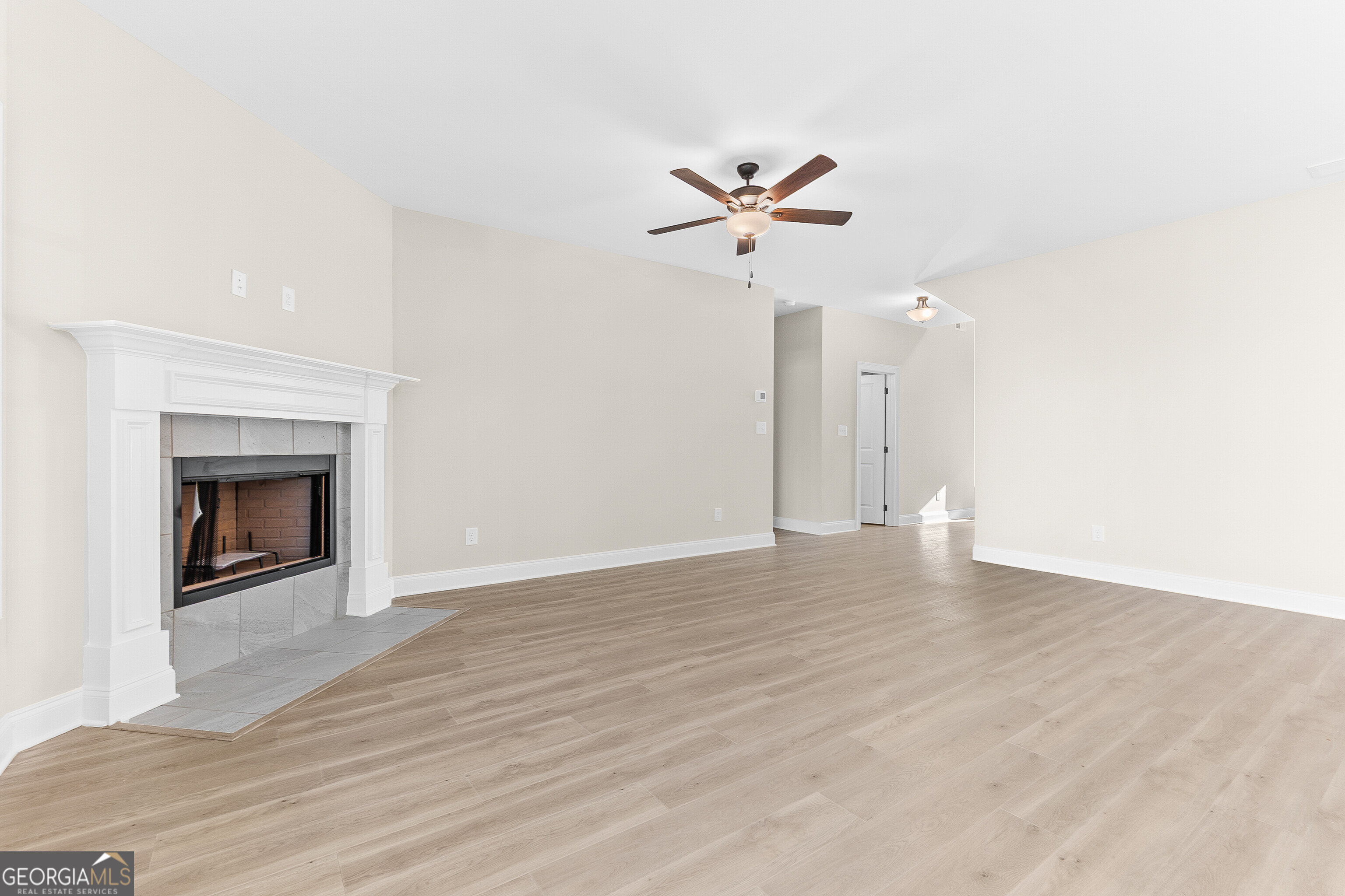 310 Air View Drive Warner Robins, GA 31093 - Photo 16 of 66 a view of an empty room with wooden floor and a fireplace