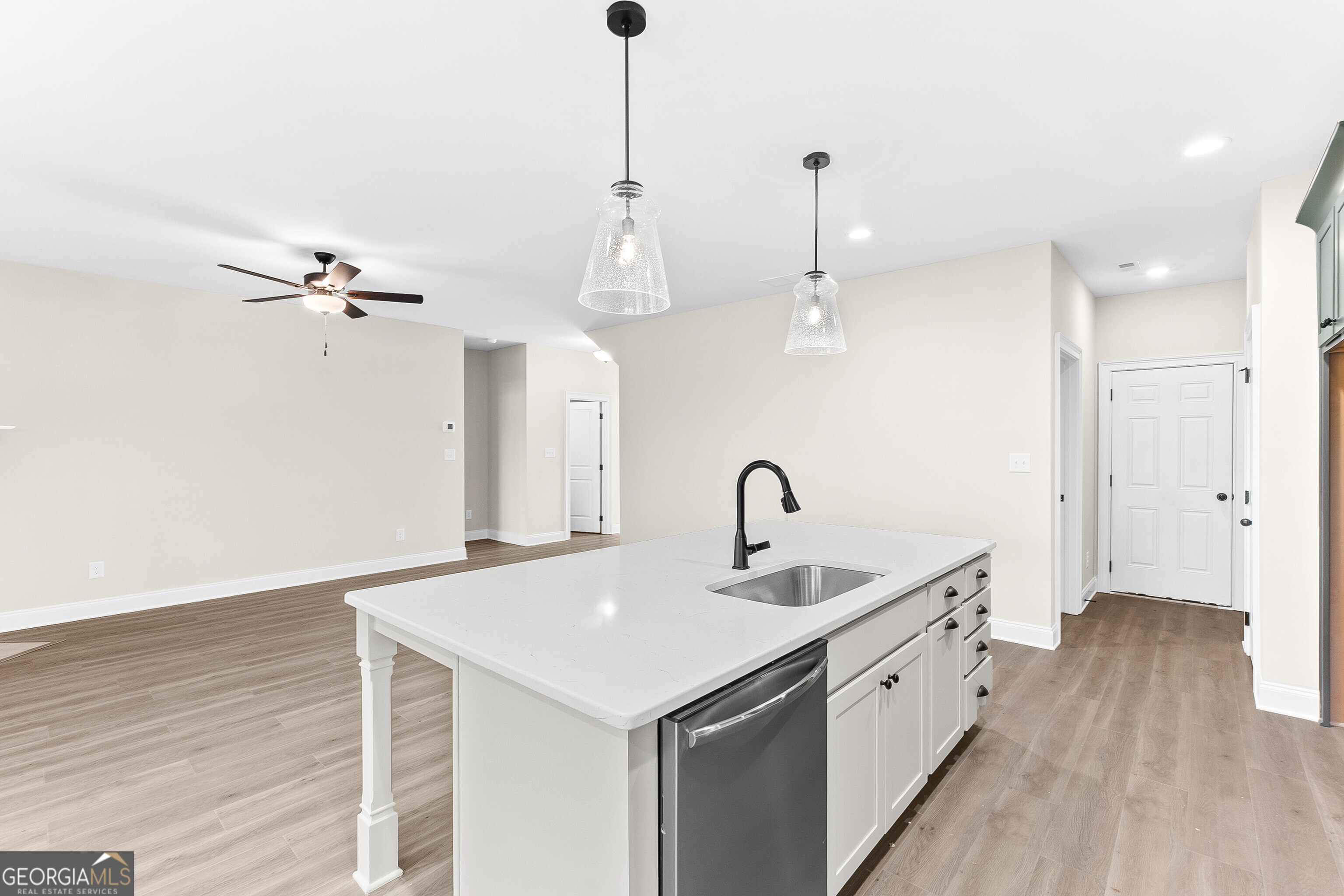 310 Air View Drive Warner Robins, GA 31093 - Photo 27 of 66 a kitchen with a sink chandelier and wooden floor