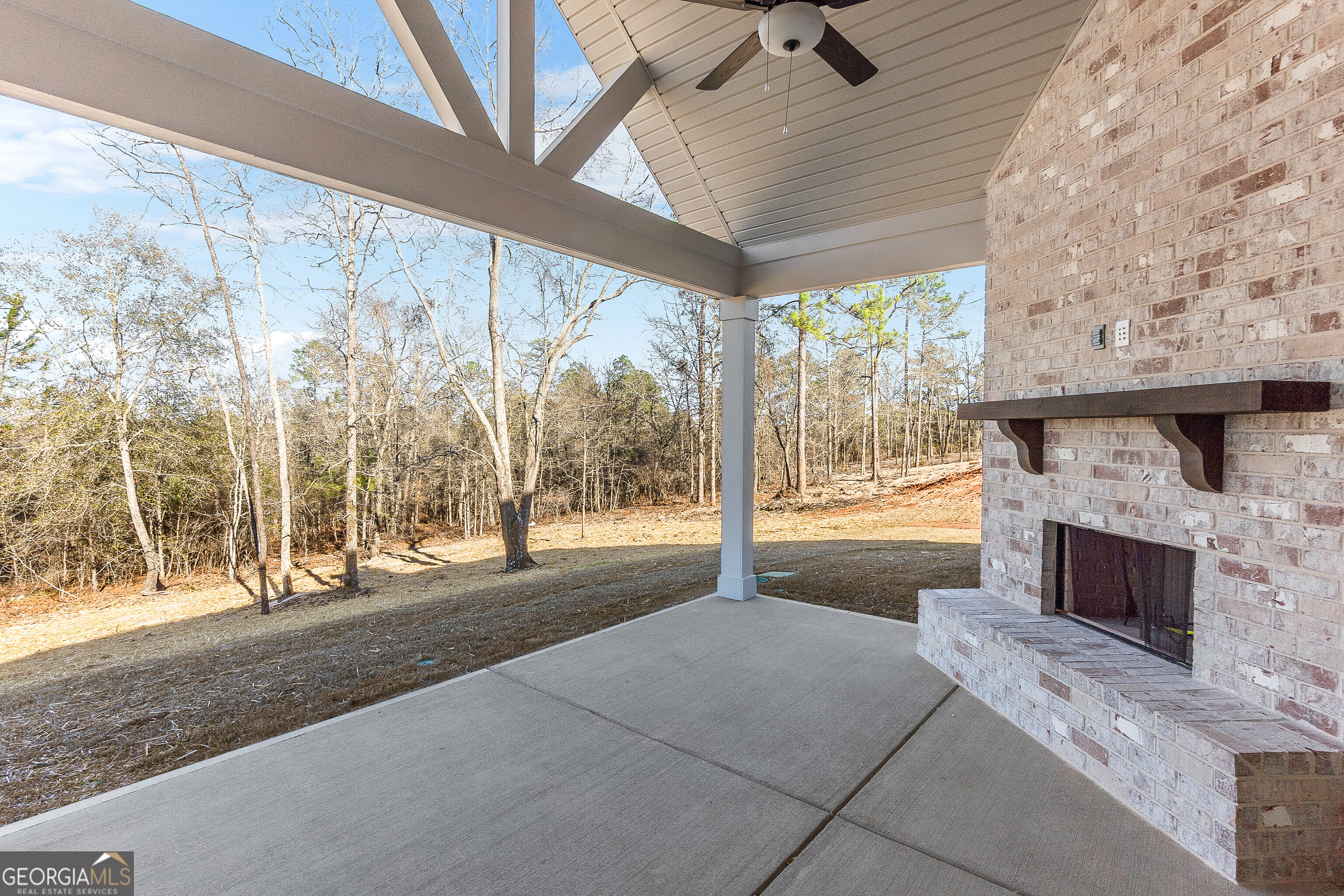 310 Air View Drive Warner Robins, GA 31093 - Photo 57 of 66 a spacious bedroom with a large bed and a fireplace