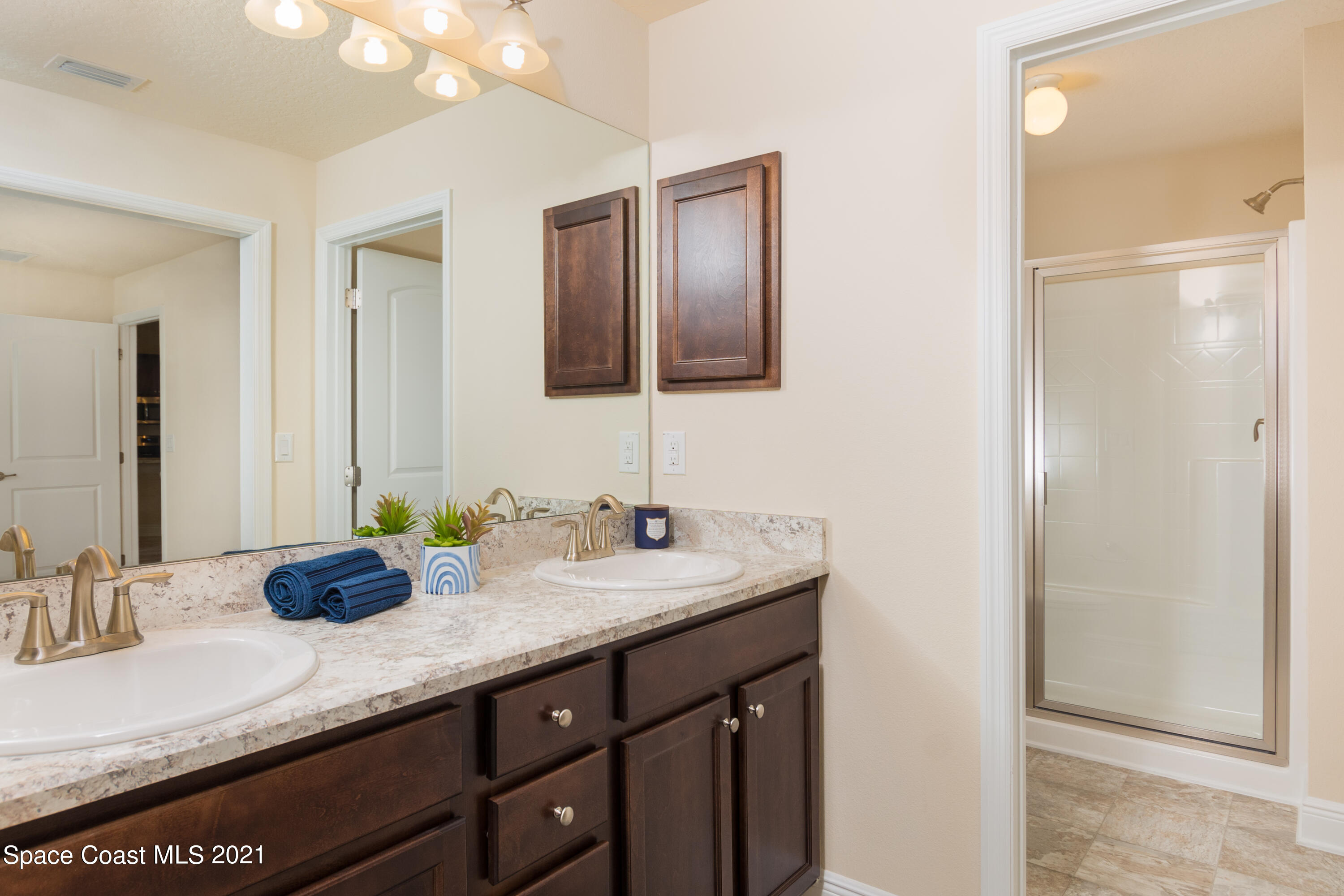 350 Garvey Road Palm Bay, FL 32908 - Photo 8 of 13 a bathroom with a granite countertop double vanity sink and a mirror