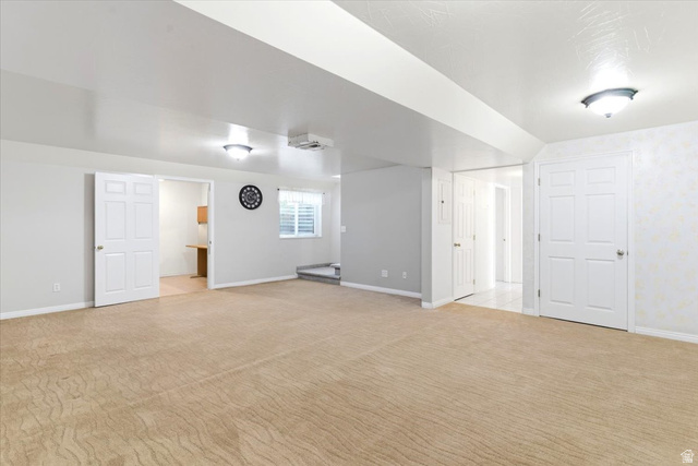 72 Canal Bank Road Garland, UT 84312 - Photo 23 of 40 Carpeted interior space featuring white trim, multiple paneled doors, and ceiling-mounted light fixtures