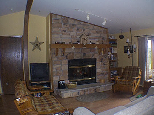 9110 East Weber Road Ridott, IL 61067 - Photo 3 of 12 a living room with furniture a flat screen tv and a fireplace