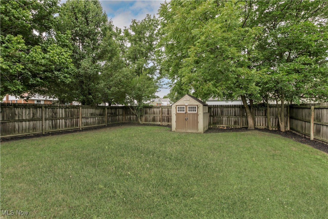 1604 Biltmore Road Cleveland, OH 44124 - Photo 32 of 40 View of backyard with wood privacy fence and storage shed. Great yard for pets, children to play, or entertain in the warmer weather.
