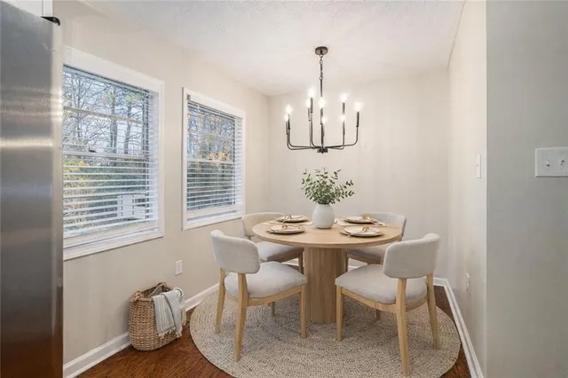 a view of a dining room with furniture a chandelier and wooden floor