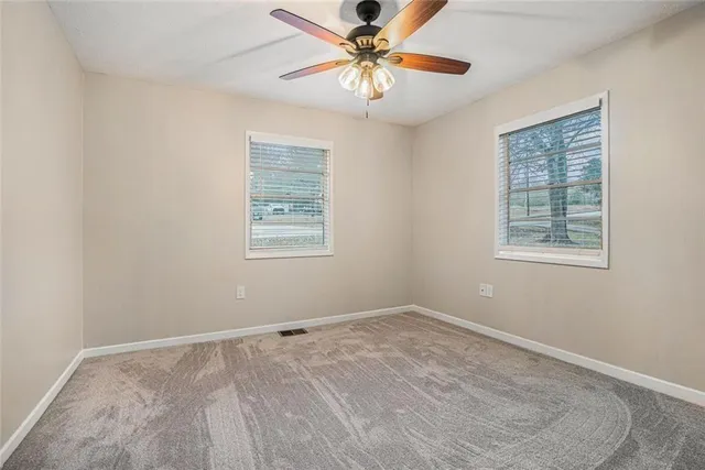a view of a room with window and a ceiling fan