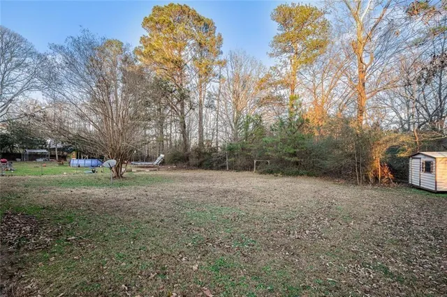 a view of a field with trees in the background