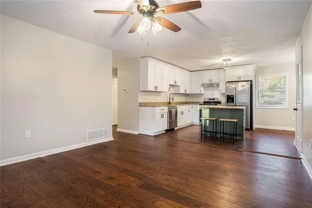 a view of kitchen with sink and wooden floor