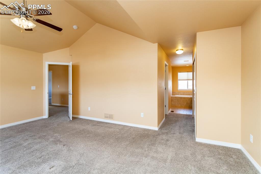 7160 Red Cardinal Loop Colorado Springs, CO 80908 - Photo 12 of 49 a view of a big room with a chandelier fan and a bathroom