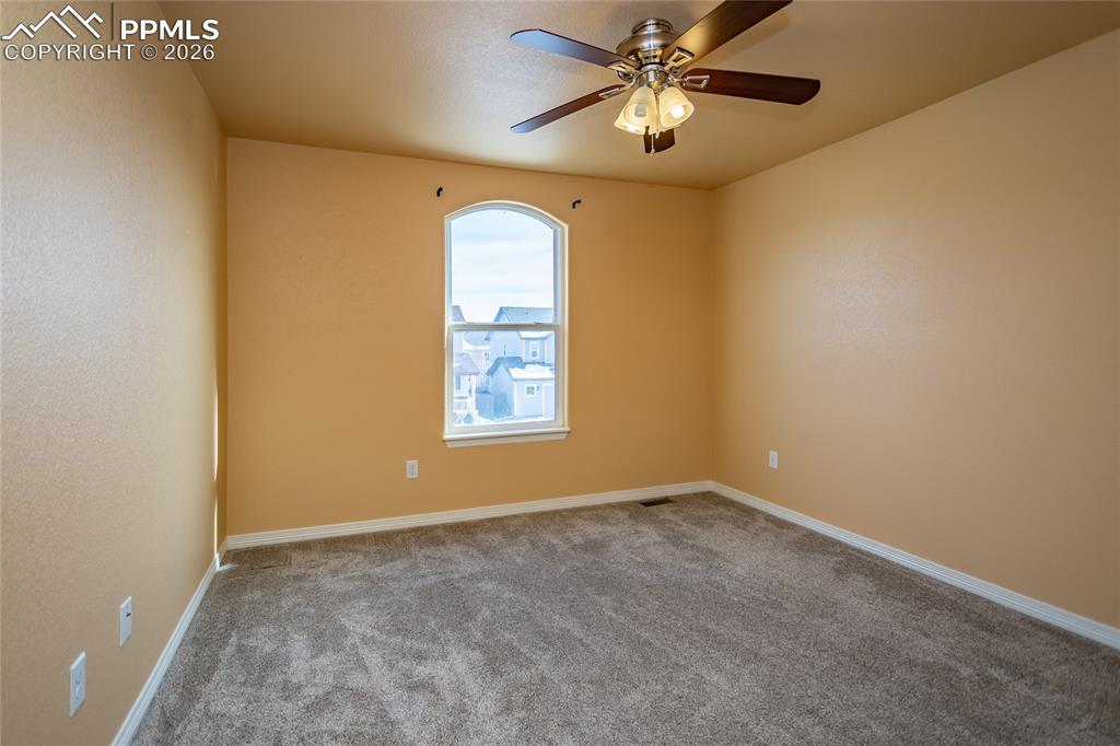 7160 Red Cardinal Loop Colorado Springs, CO 80908 - Photo 21 of 49 an empty room with windows and fan
