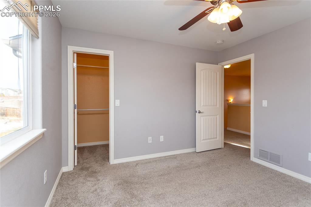 7160 Red Cardinal Loop Colorado Springs, CO 80908 - Photo 26 of 49 an empty room with a bathroom and a chandelier fan