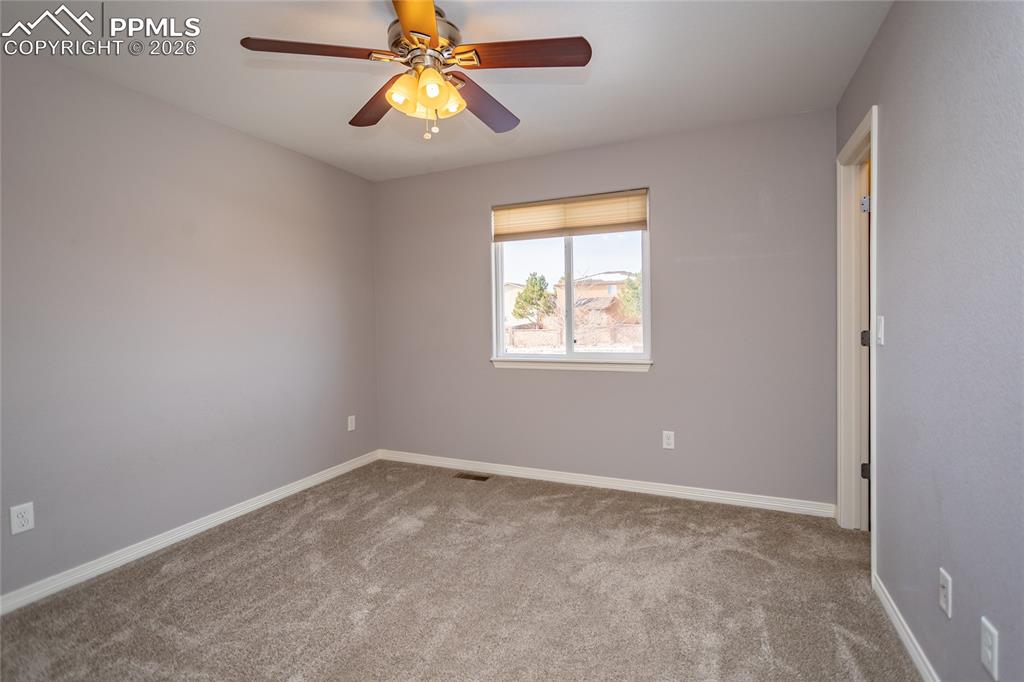 7160 Red Cardinal Loop Colorado Springs, CO 80908 - Photo 27 of 49 an empty room with windows and fan