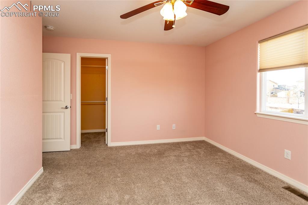 7160 Red Cardinal Loop Colorado Springs, CO 80908 - Photo 29 of 49 an empty room with a window and a ceiling fan