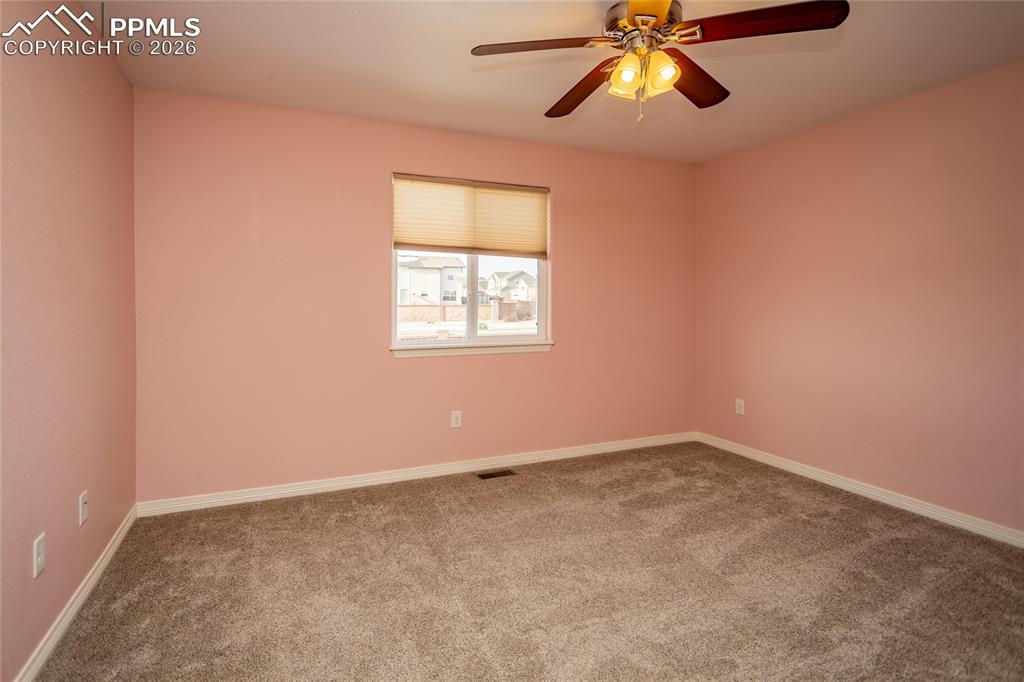 7160 Red Cardinal Loop Colorado Springs, CO 80908 - Photo 30 of 49 an empty room with window and a ceiling fan