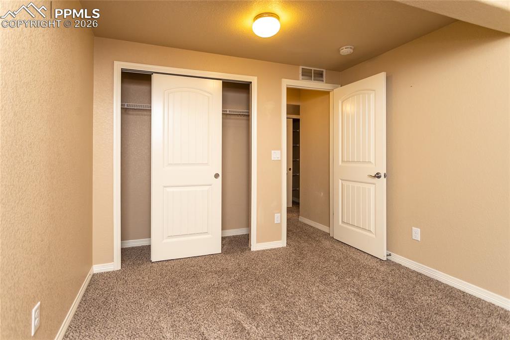 7160 Red Cardinal Loop Colorado Springs, CO 80908 - Photo 34 of 49 an empty room with closet and a bathroom