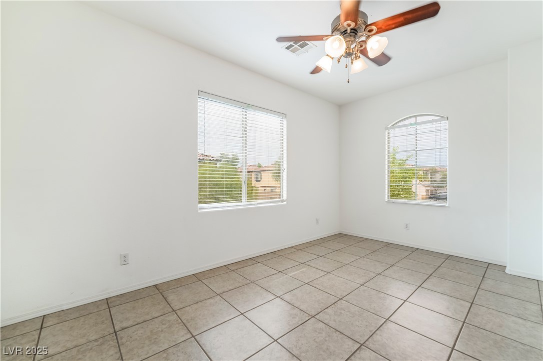 648 Sumatra Place Henderson, NV 89011 - Photo 23 of 31 Spare room with light tile patterned floors and ceiling fan