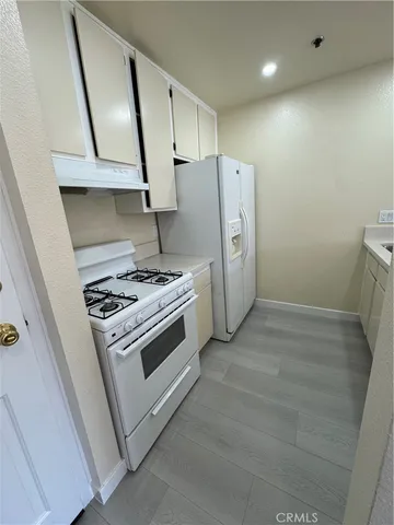 a kitchen with a stove a refrigerator and a sink