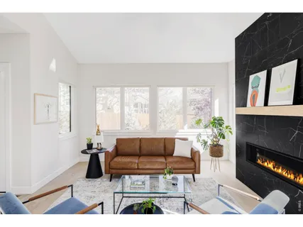 a living room with furniture a window and a fireplace