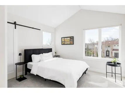 a bedroom with a large bed and a large window