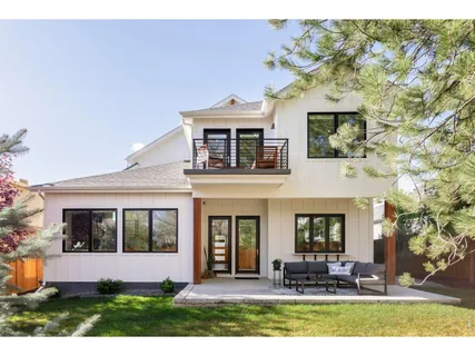 a backyard of a house with table and chairs