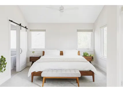 a bedroom with a bed a table and chair