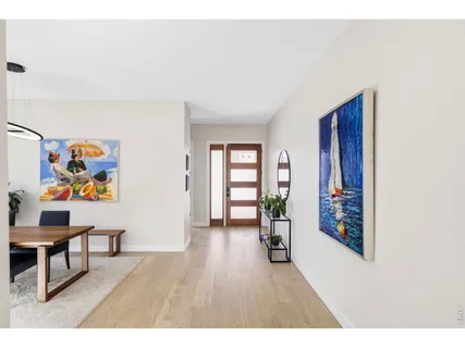 a view of an empty room with painting on the wall