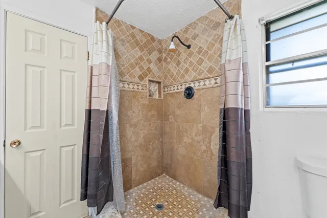 a bathroom with a sink a toilet and a shower