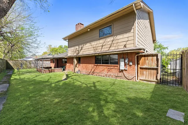 a backyard of a house with table and chairs