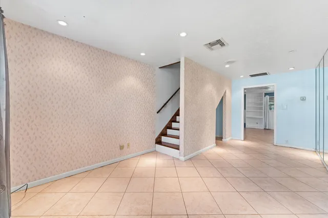 a view of an empty room with stairs