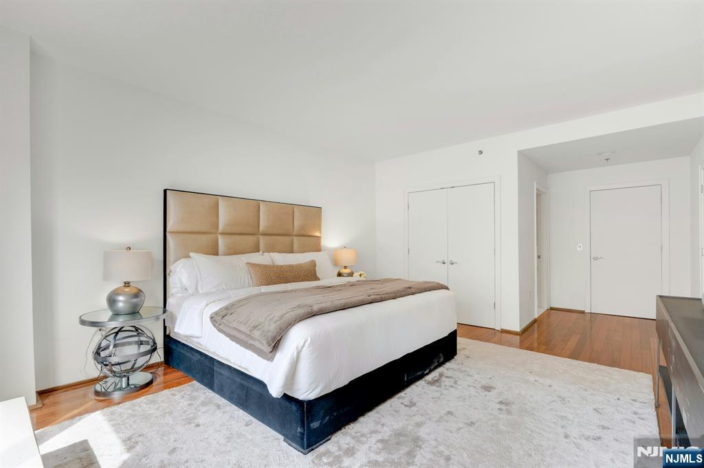 3219 City Place Edgewater, NJ 07020 - Photo 14 of 28 a bedroom with a bed and a mirror