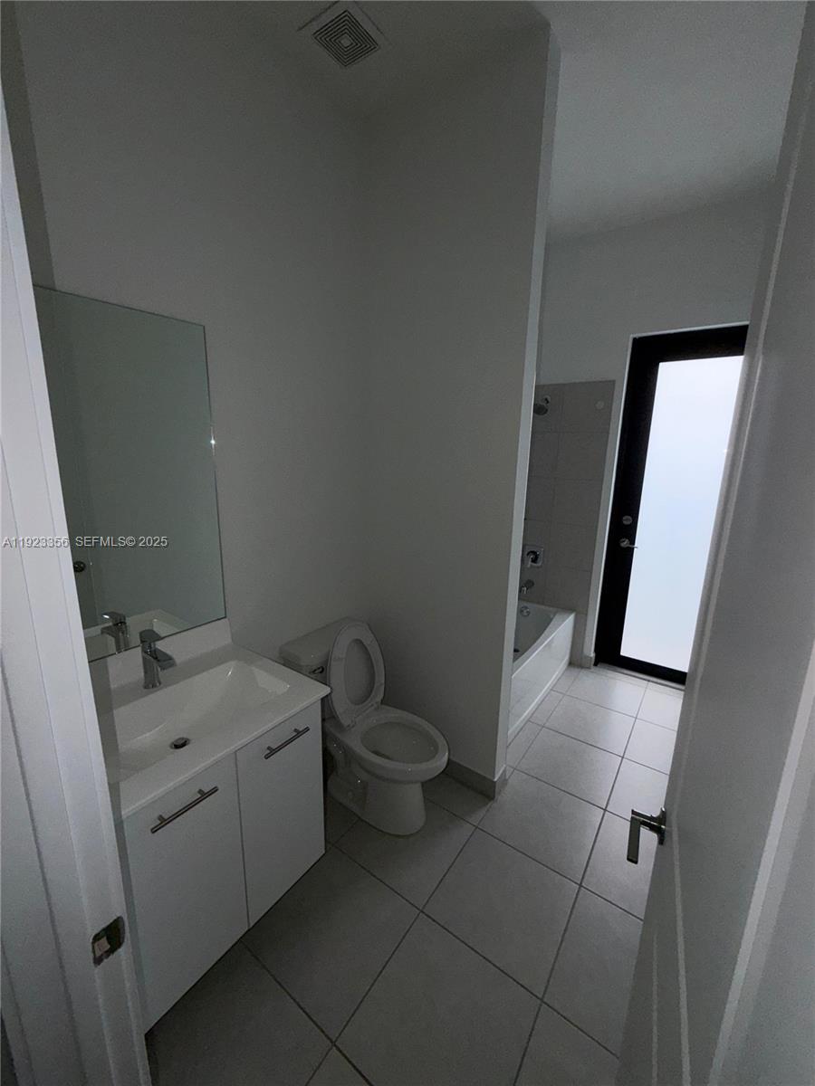 4321 Southwest 173rd Avenue Miramar, FL 33029 - Photo 13 of 28 a bathroom with a sink a toilet and a mirror