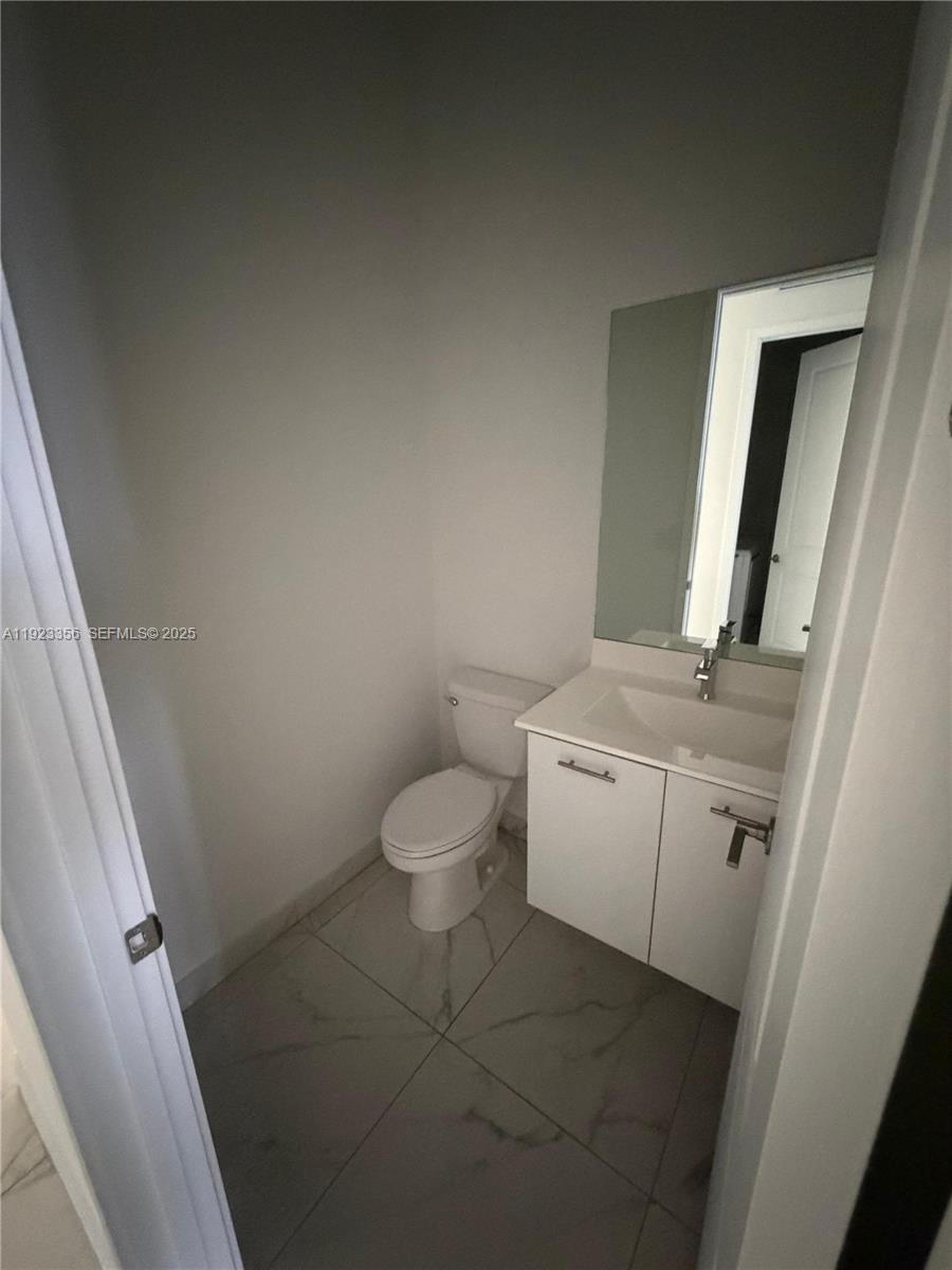 4321 Southwest 173rd Avenue Miramar, FL 33029 - Photo 15 of 28 a bathroom with a sink a toilet and mirror