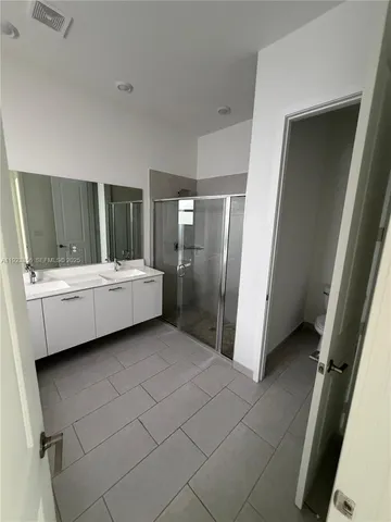 a bathroom with a double vanity sink and mirror