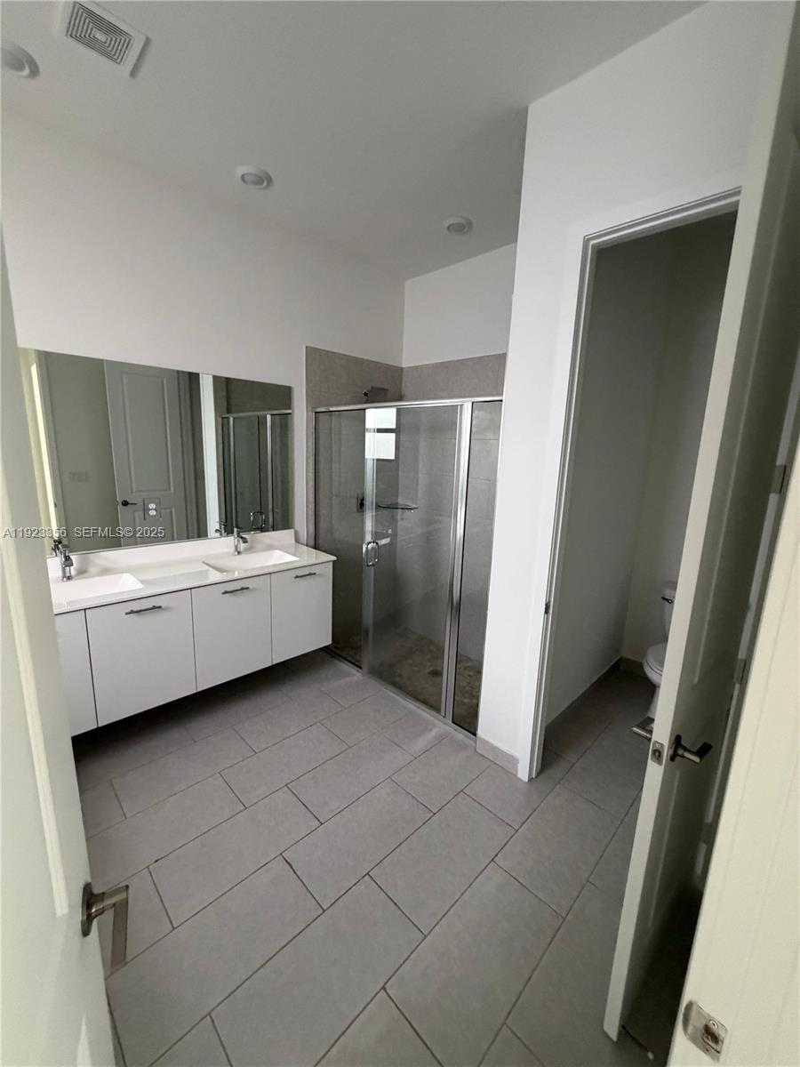 4321 Southwest 173rd Avenue Miramar, FL 33029 - Photo 18 of 28 a bathroom with a double vanity sink and mirror
