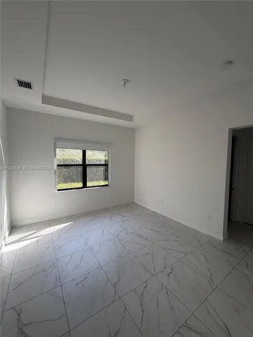 an empty room with a empty space and window